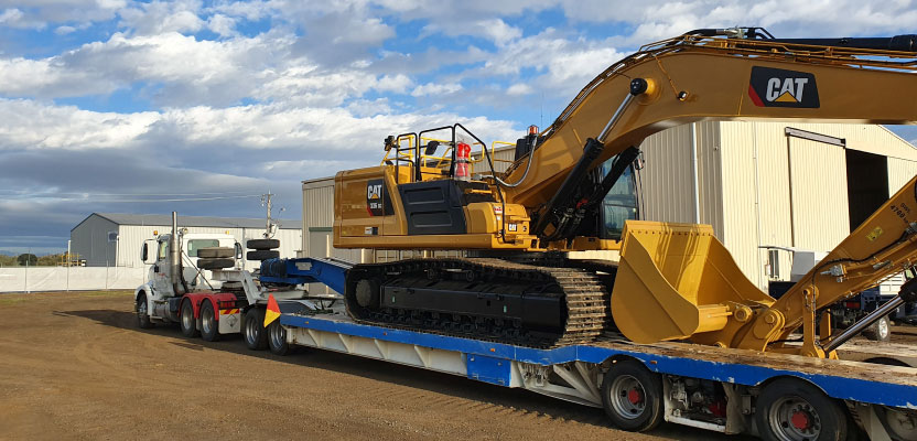 mine excavator on truck transport